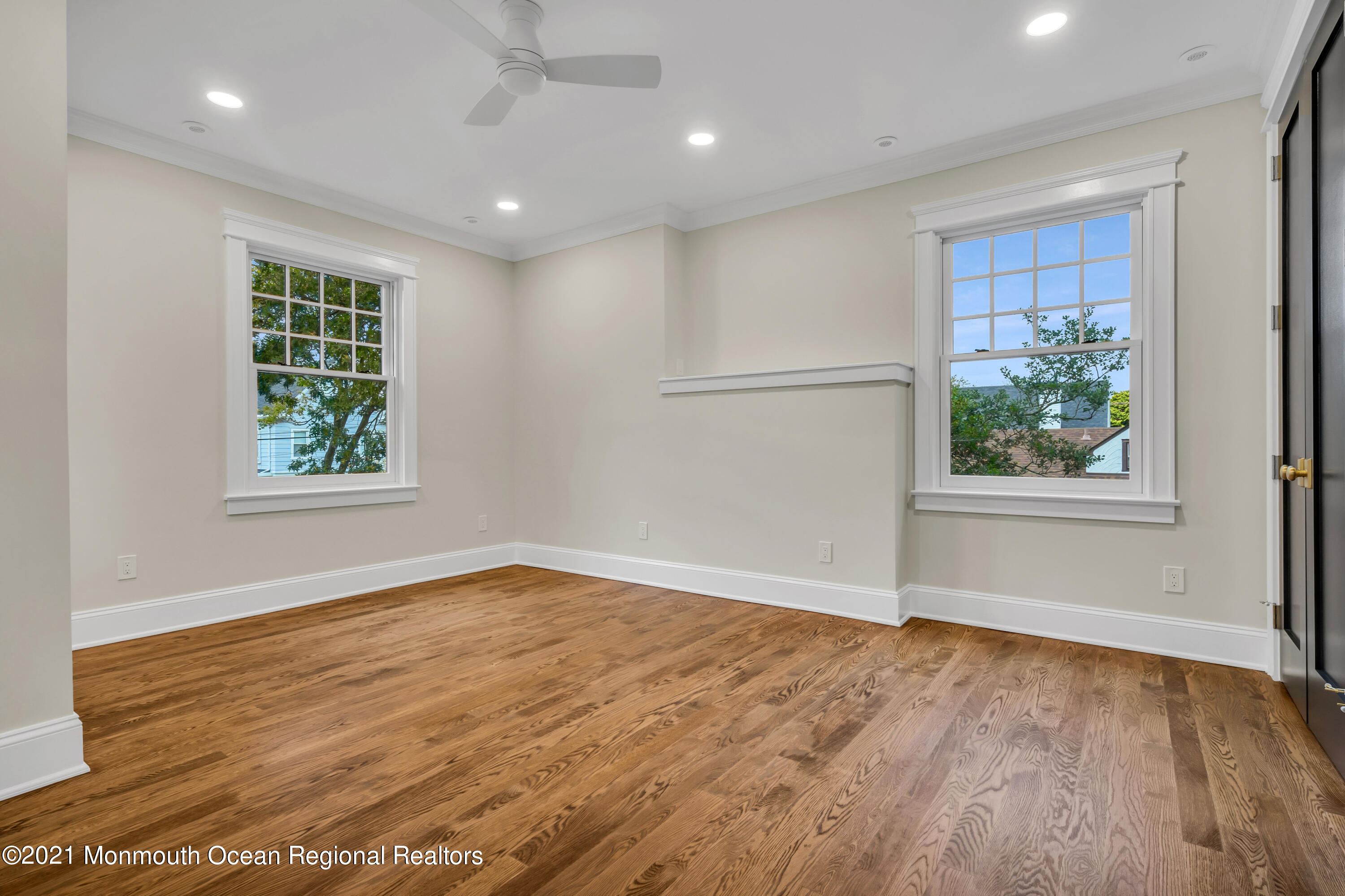 222 Cedar Avenue Allenhurst, NJ 07711 - Photo 42 of 73 a view of an empty room with wooden floor and a window