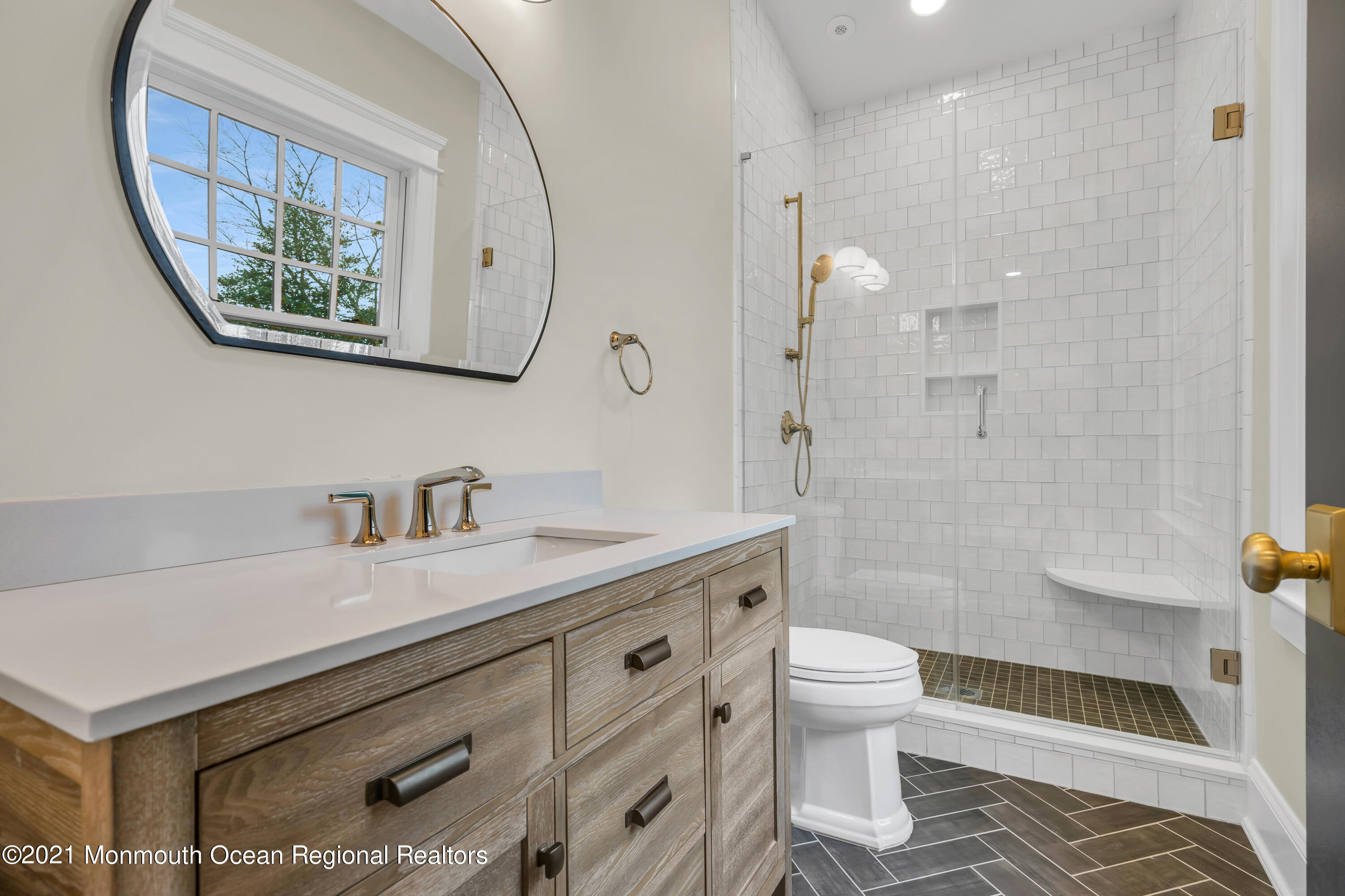 222 Cedar Avenue Allenhurst, NJ 07711 - Photo 44 of 73 a bathroom with a sink a toilet and a mirror