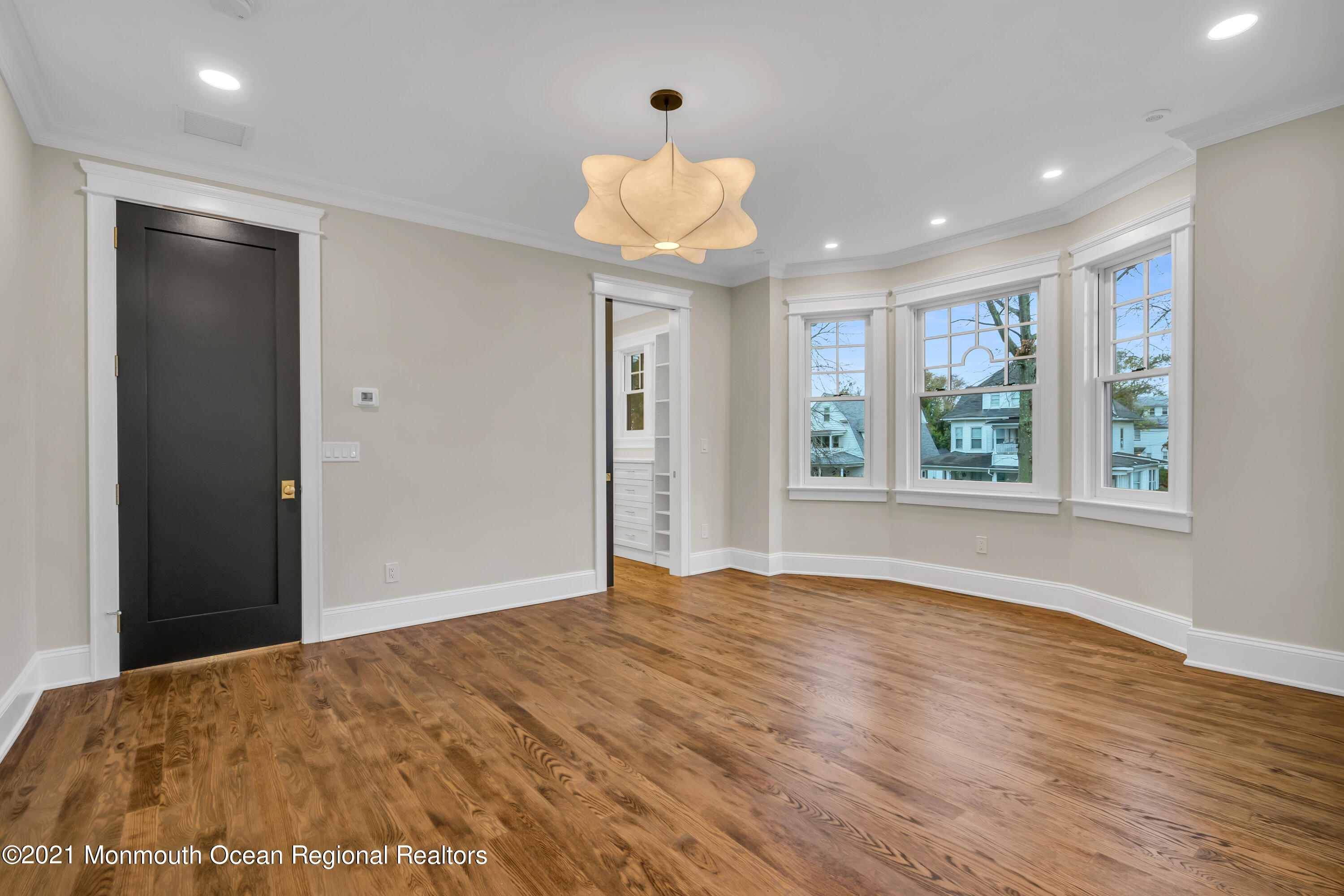 222 Cedar Avenue Allenhurst, NJ 07711 - Photo 46 of 73 a view of an empty room with a window and wooden floor