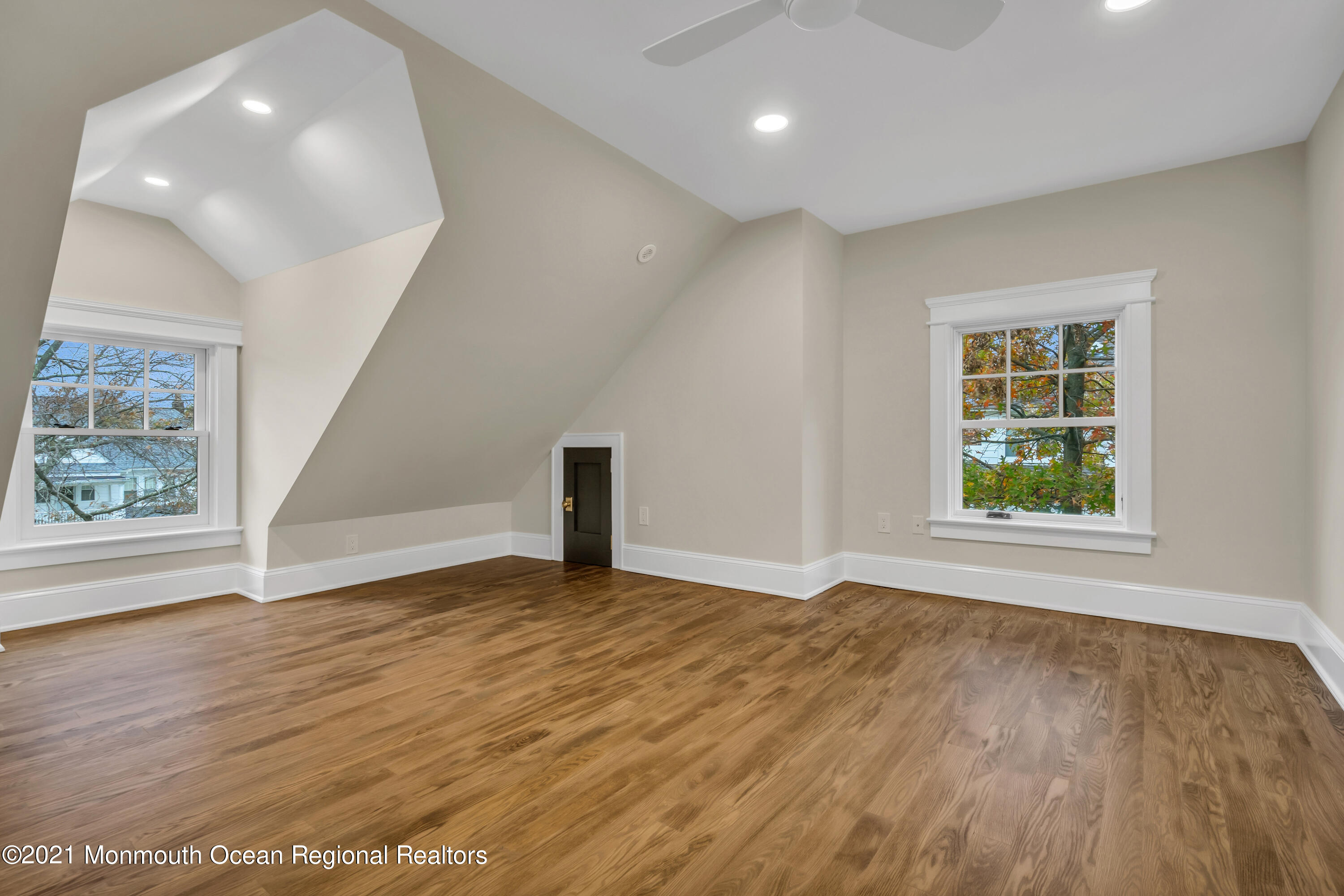222 Cedar Avenue Allenhurst, NJ 07711 - Photo 56 of 73 an empty room with wooden floor and windows