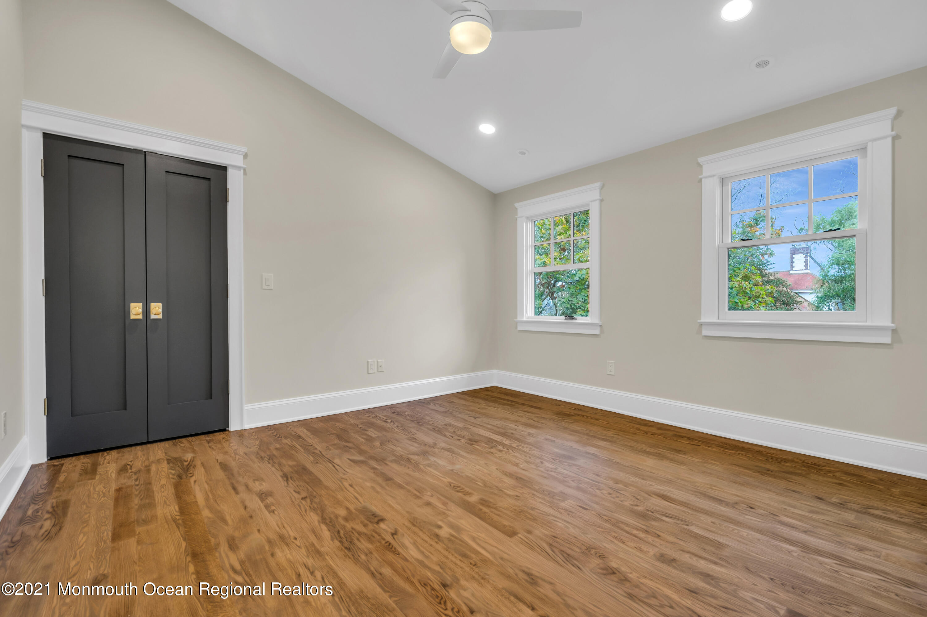 222 Cedar Avenue Allenhurst, NJ 07711 - Photo 58 of 73 a view of an empty room with wooden floor and a window
