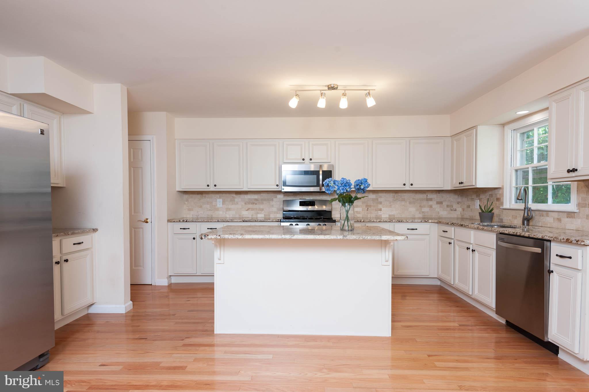 1656 Comanche Road Arnold, MD 21012 - Photo 8 of 30 Kitchen has wood floors and doorway to backyard.