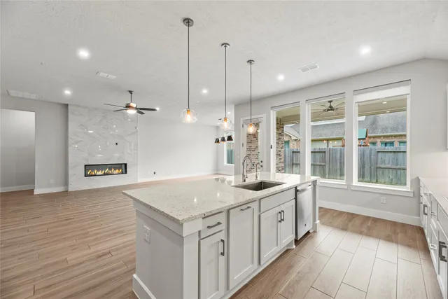 a view of a kitchen with a sink and wooden floor