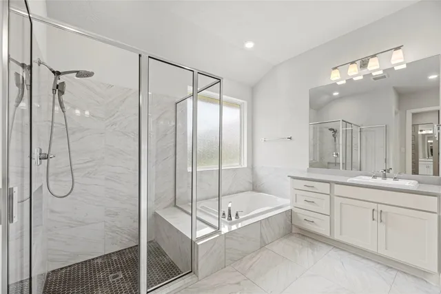 a spacious bathroom with a shower sink and mirror
