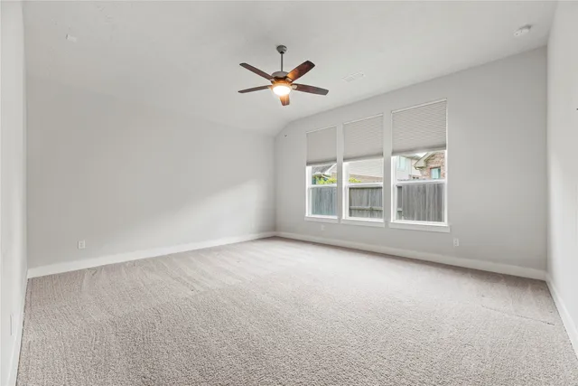 a view of a livingroom with a ceiling fan and window