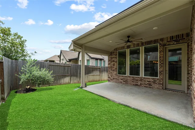 a view of an house with backyard porch and garden