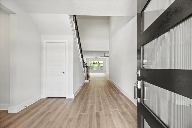 a view of a hallway view with wooden floor and staircase
