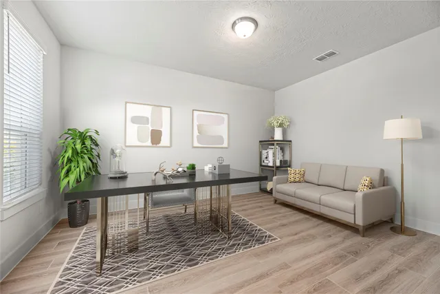 a living room with furniture and wooden floor