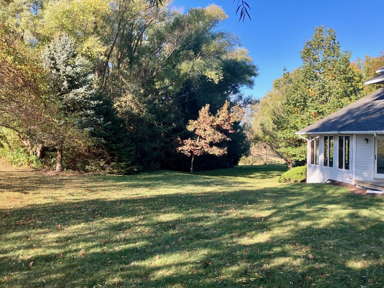 7561 West Judson Road Polo, IL 61064 - Photo 36 of 44 a view of a house with a big yard and a large tree