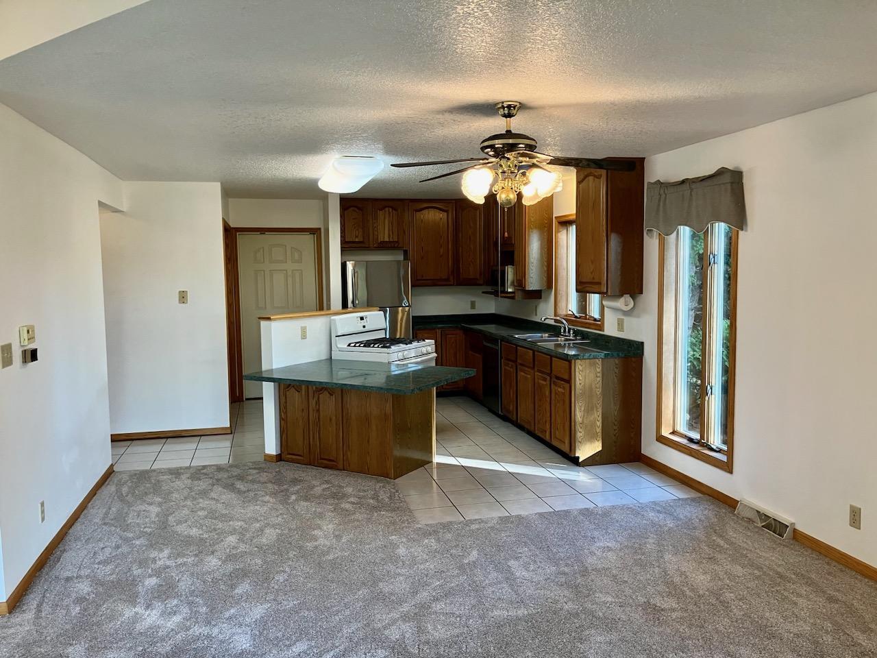 7561 West Judson Road Polo, IL 61064 - Photo 5 of 44 a view of kitchen with refrigerator stove microwave and furniture