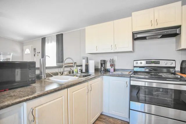 a stove top oven sitting inside of a kitchen