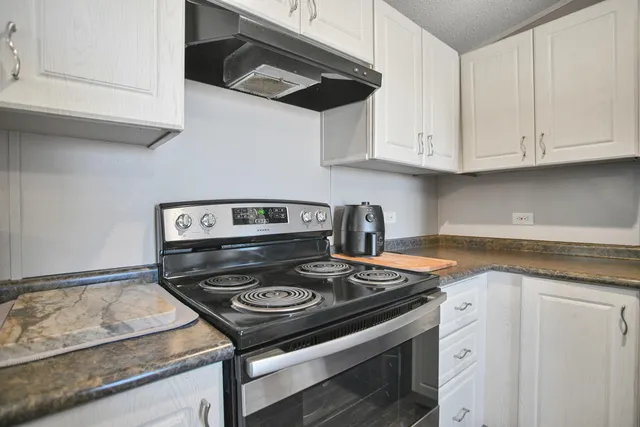 a kitchen with kitchen island granite countertop a table and chairs in it