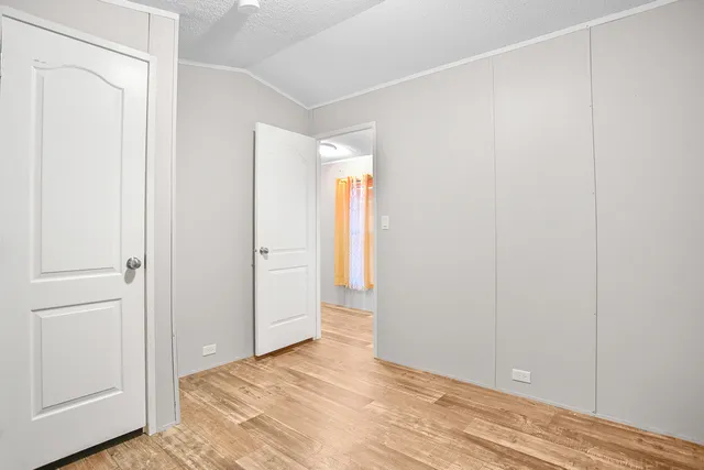 a view of a room with wooden floor