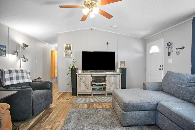 a living room with furniture and kitchen view