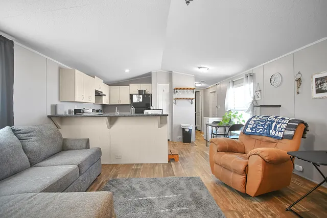 a kitchen with a refrigerator sink and cabinets