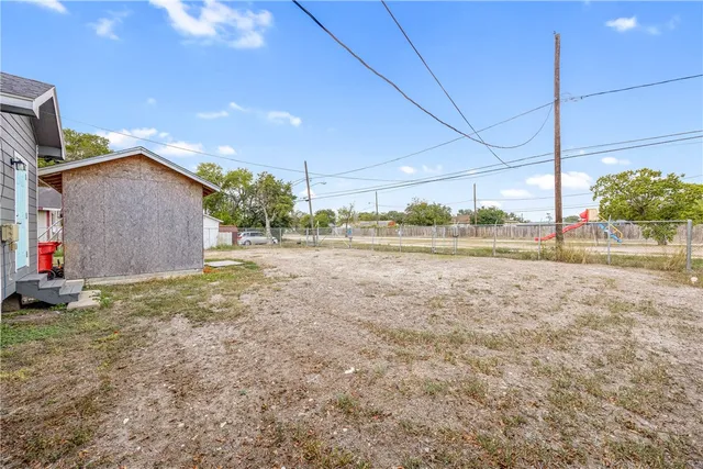 a view of a backyard of the house