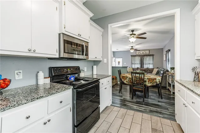 a kitchen with stainless steel appliances granite countertop a stove and cabinets