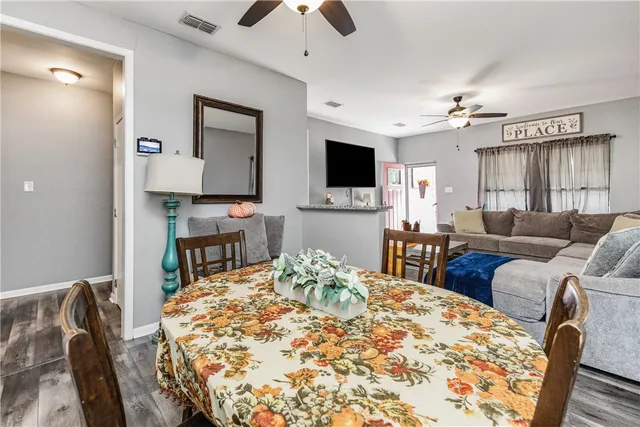 a living room with furniture a flat screen tv and a chandelier