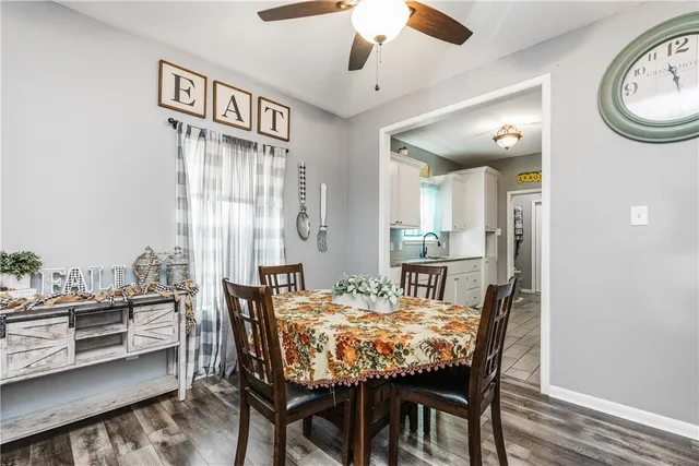a view of a dining room with furniture and a chandelier
