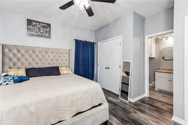 a bedroom with a large bed and a chandelier