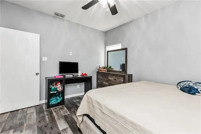 a bed room with a bed and a television