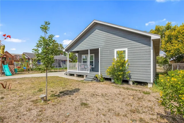 a house that has a tree in front of it