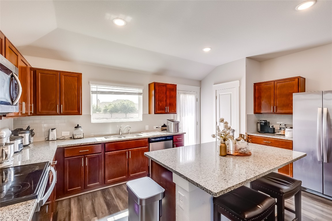 1104 Terrace View Georgetown, TX 78628 - Photo 10 of 36 a kitchen with a table chairs sink and cabinets