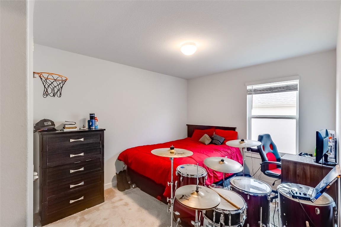 1104 Terrace View Georgetown, TX 78628 - Photo 24 of 36 a bedroom with a bed and a dresser