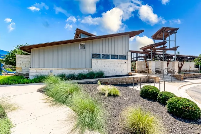 a view of a house with a yard and a patio
