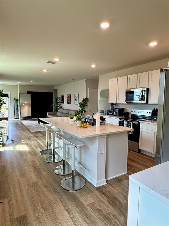 3222 Bitterroot Lane Bradenton, FL 34211 - Photo 4 of 12 a view of kitchen with stainless steel appliances refrigerator stove microwave and cabinets