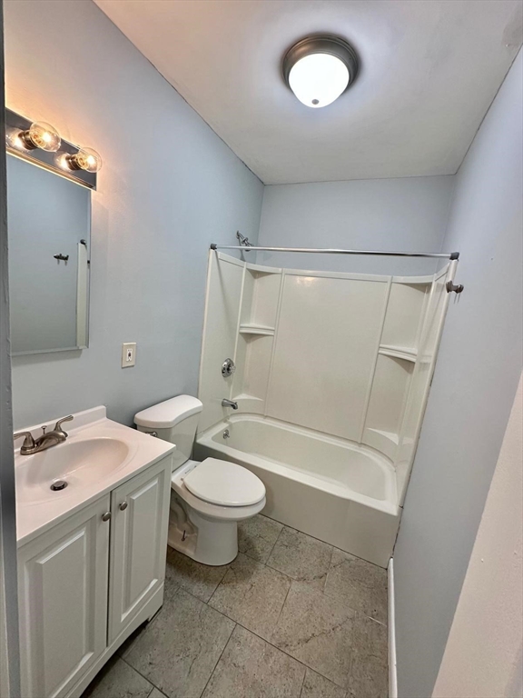 363 Hildreth Street, Unit 11 Lowell, MA 01850 - Photo 4 of 17 a bathroom with a double vanity sink toilet mirror and shower