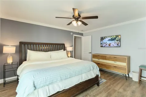 a bedroom with a bed and a chandelier