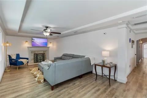 a living room with furniture and a chandelier