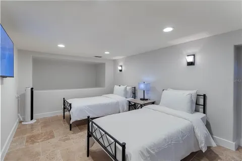a bedroom with two beds and a desk