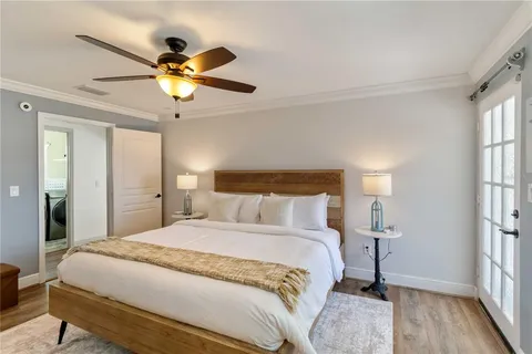 a bedroom with a large bed and a chandelier