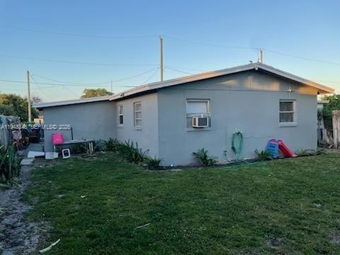 1489 West 34th Street Riviera Beach, FL 33404 - Photo 2 of 6 a backyard of a house with table and chairs