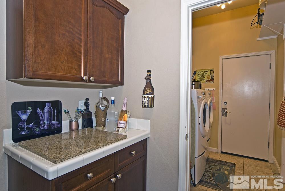 1795 Arrow Wood Court Reno, NV 89521 - Photo 16 of 40 a room with granite countertop a refrigerator and cabinets