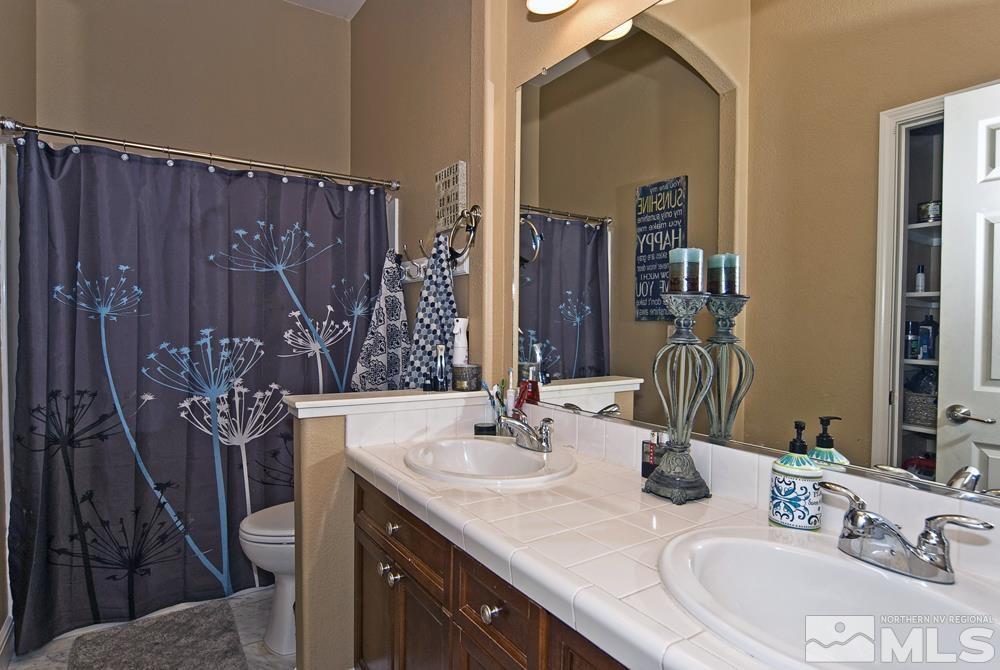 1795 Arrow Wood Court Reno, NV 89521 - Photo 18 of 40 a bathroom with a sink vanity and a mirror