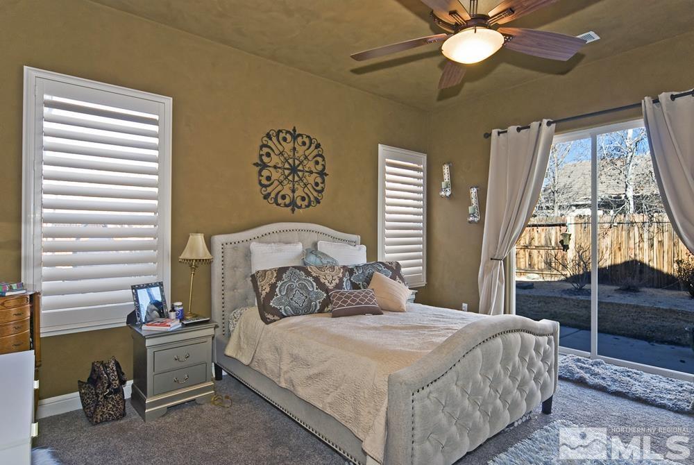 1795 Arrow Wood Court Reno, NV 89521 - Photo 19 of 40 a bedroom with a bed and a chandelier