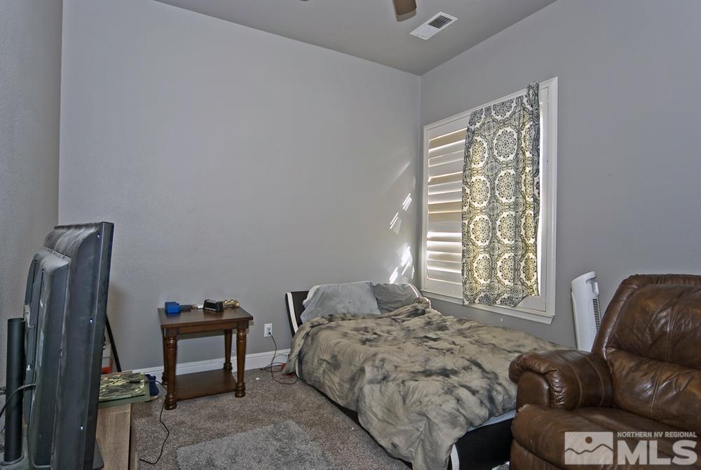 1795 Arrow Wood Court Reno, NV 89521 - Photo 27 of 40 a bedroom with a bed and a couch