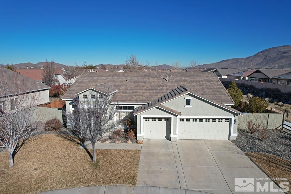 1795 Arrow Wood Court Reno, NV 89521 - Photo 34 of 40 a view of a big house with a mountain in the background