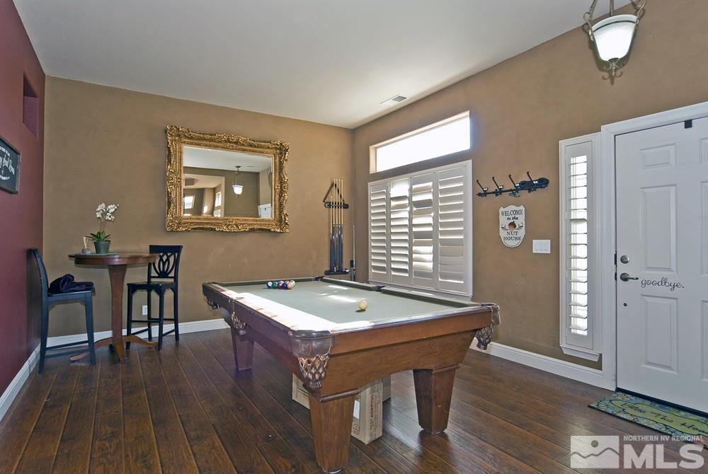 1795 Arrow Wood Court Reno, NV 89521 - Photo 5 of 40 a room with furniture pool table wooden floor and windows