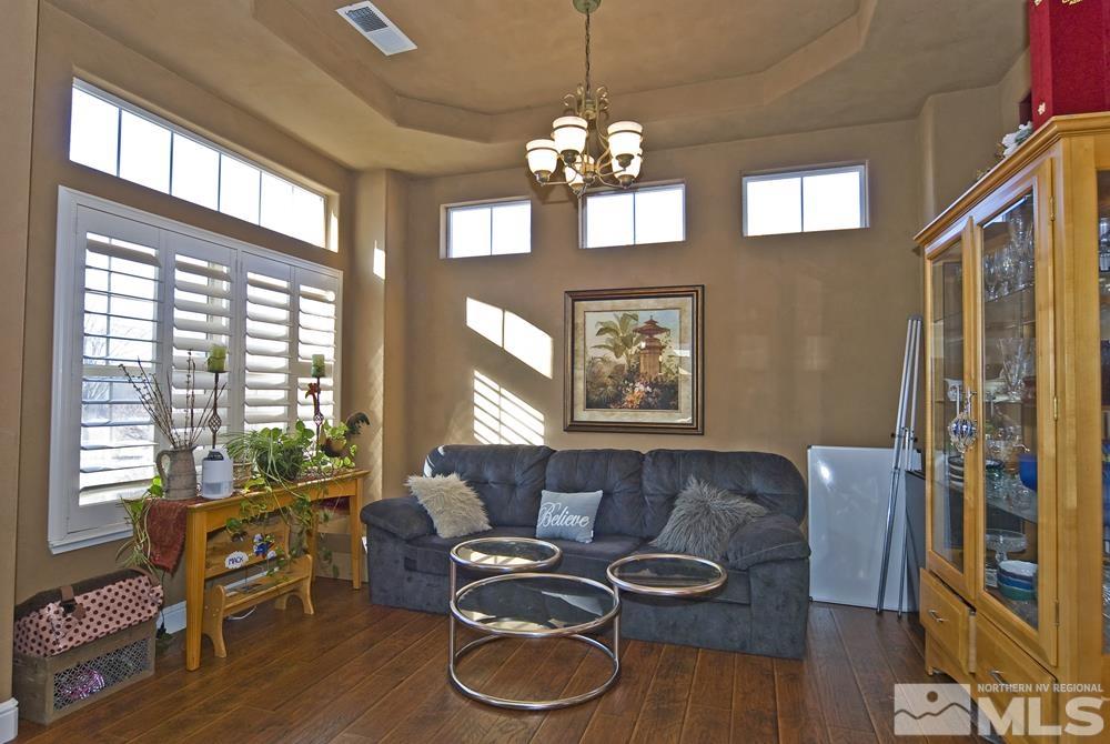 1795 Arrow Wood Court Reno, NV 89521 - Photo 6 of 40 a living room with furniture a fireplace and a flat screen tv