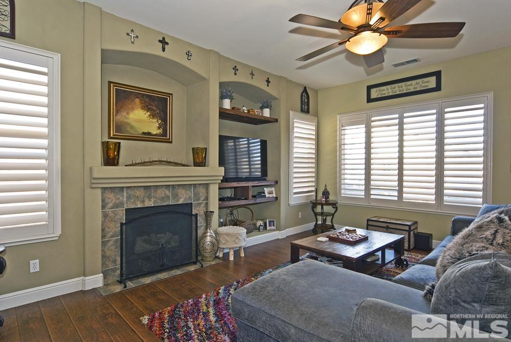 1795 Arrow Wood Court Reno, NV 89521 - Photo 9 of 40 a living room with furniture a window and a fireplace