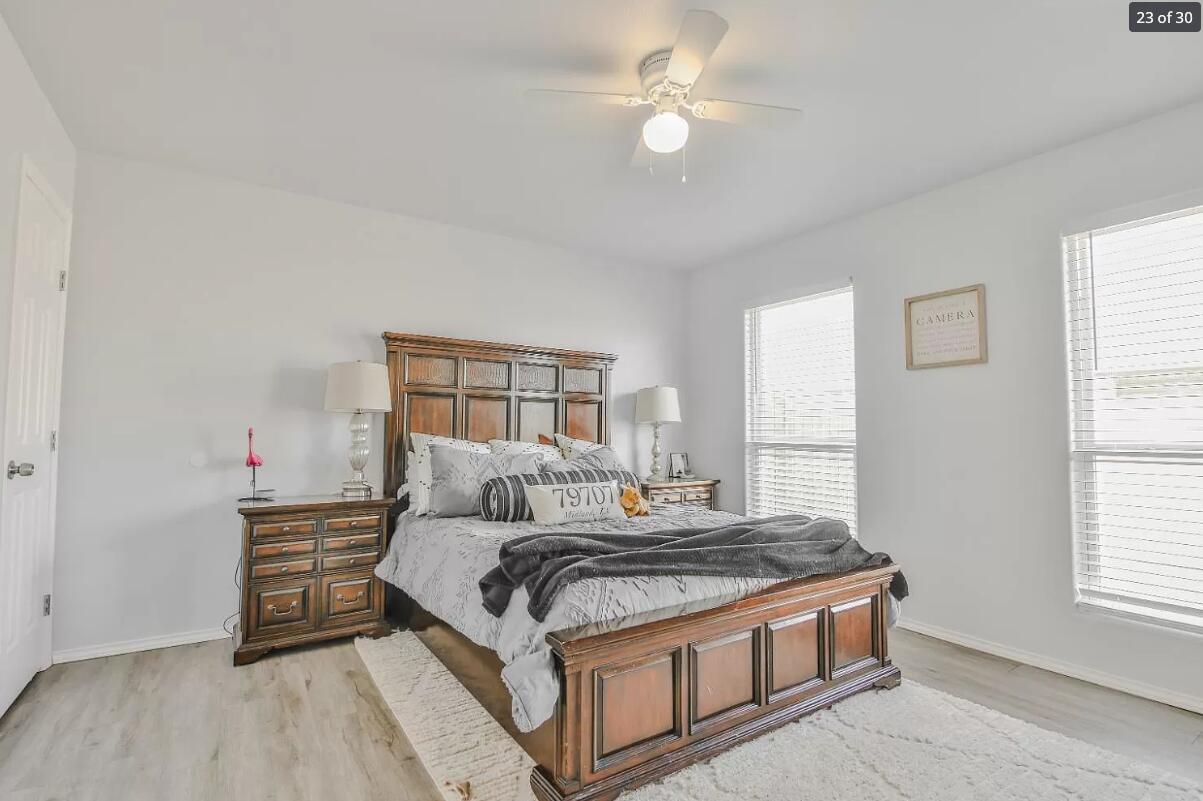 5502 Jarvis Street, Unit B Lubbock, TX 79416 - Photo 11 of 13 a living room with a bed furniture and a window