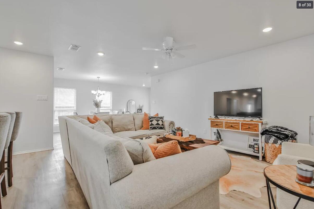 5502 Jarvis Street, Unit B Lubbock, TX 79416 - Photo 2 of 13 a living room with furniture and a flat screen tv