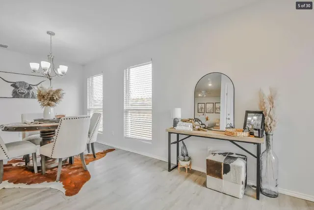 a dining room with furniture and window