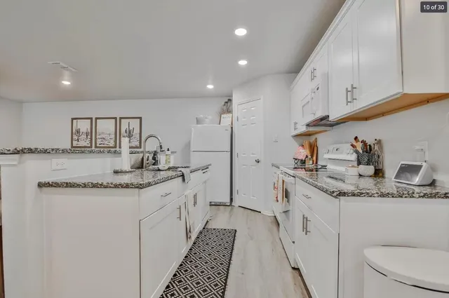 a kitchen with a sink stove and cabinets