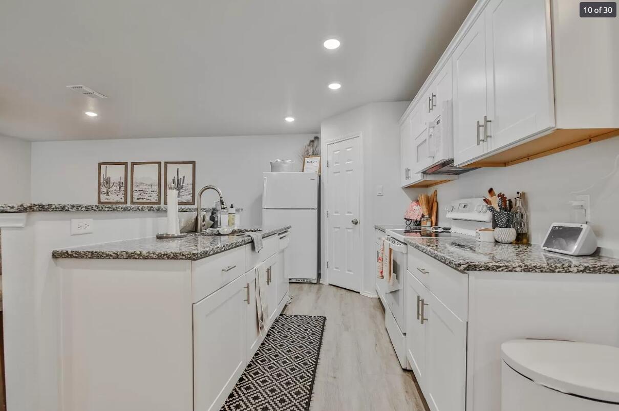 5502 Jarvis Street, Unit B Lubbock, TX 79416 - Photo 6 of 13 a kitchen with a sink stove and cabinets