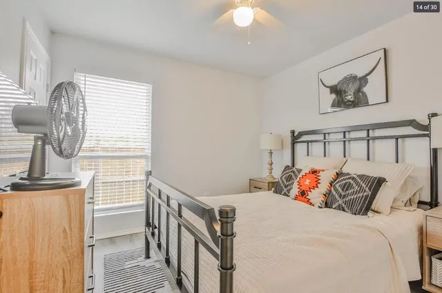 a bed sitting in a bedroom next to a window